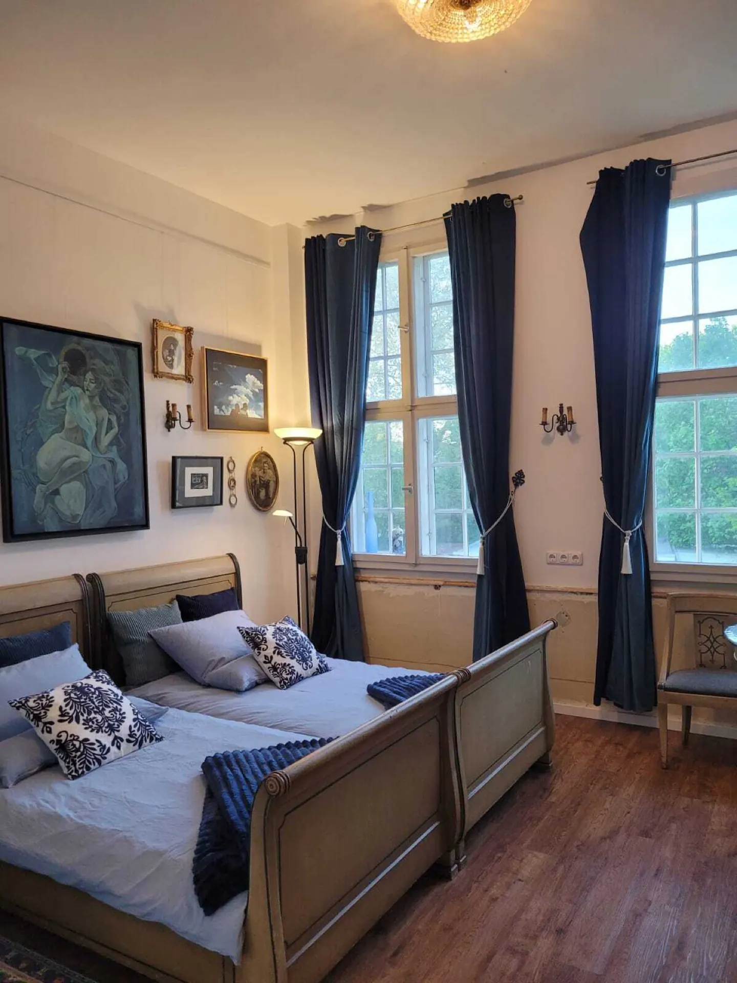 A bedroom with a blue bed under the sloping roof.