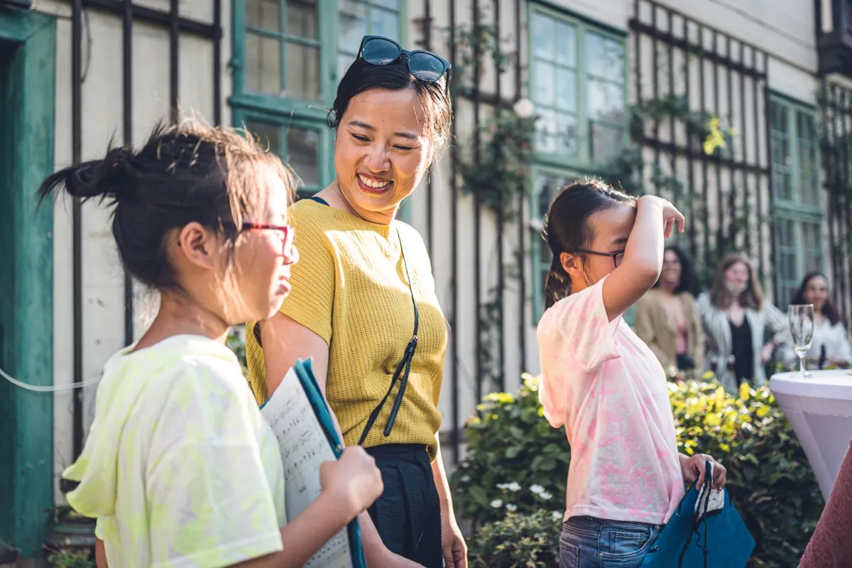 Young people laughing together in warm light.