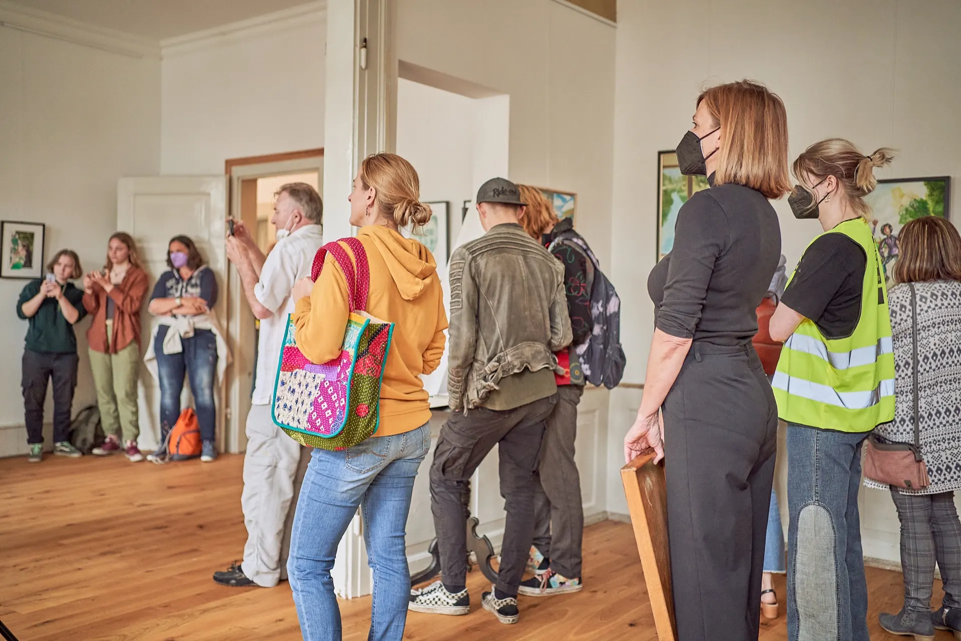 Exhibition room on the ground floor with framed works on the walls.